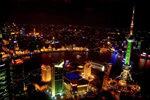 Shanghai China wonderful skyline with modern skyscrapers by river at night from above Shanghai China wonderful skyline with modern skyscrapers by river at night from above