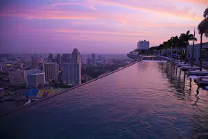 Images Dated 31st July 2011: Singapore, Marina Bay Sands Hotel. Cantilevered hotel swimming pool at sunrise. Credit as