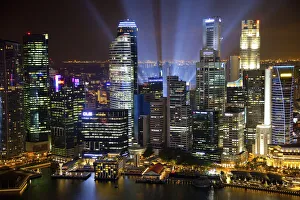 Singapore. Searchlights and city building at night Singapore. Searchlights and city building at night