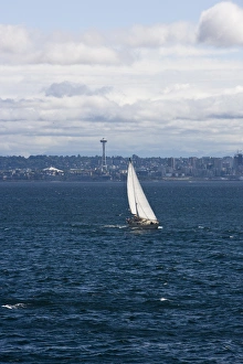A small sailboat is propelled by a strong burst of wind off the coast of Seattle A small sailboat is propelled by a strong burst of wind off the coast of Seattle