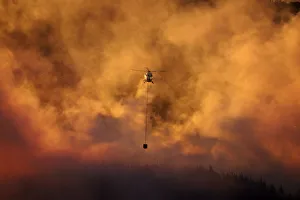 Smokey sunset and helicopter fighting fire at Burnside, Dunedin, South Island, New Smokey sunset and helicopter fighting fire at Burnside, Dunedin, South Island, New