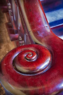 Snail shell-like curve on red wooden bannister handrail in Trinidad, Cuba Snail shell-like curve on red wooden bannister handrail in Trinidad, Cuba