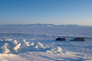 snow machine and sled on the frozen Arctic ocean, off Herschel island and the Mackenzie River delta snow machine and sled on the frozen Arctic ocean, off Herschel island and the Mackenzie River delta