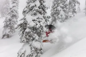 Snowboarding in powder at Whitefish Mountain Resort, Montana, USA MR Snowboarding in powder at Whitefish Mountain Resort, Montana, USA MR