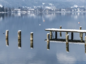 Snowy pier in winter, Lake Tegernsee, Germany Snowy pier in winter, Lake Tegernsee, Germany