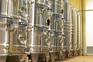 Stacks of stainless steel fermentation vats in various sizes and with cooling systems Stacks of stainless steel fermentation vats in various sizes and with cooling systems