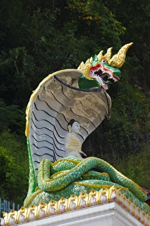 Statue of Buddha meditating with his weight supported by the coils of a naga (snake) Statue of Buddha meditating with his weight supported by the coils of a naga (snake)