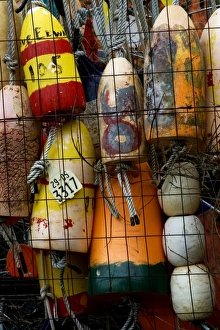 Stock photo of bouys hung on a fence at a shipyard Stock photo of bouys hung on a fence at a shipyard