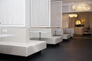 Stockholm, Sweden - Bench style booth seating in a restaurant. The tables, seating Stockholm, Sweden - Bench style booth seating in a restaurant. The tables, seating