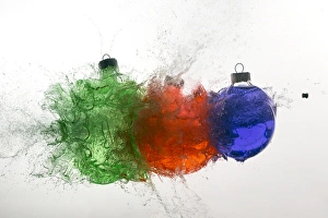 Stop action of Christmas ornaments filled with colored water and exploding form bullet Stop action of Christmas ornaments filled with colored water and exploding form bullet