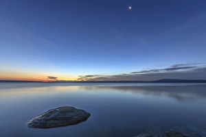 Sunrise and Moon setting over Yellowstone Lake. Yellowstone National Park. Wyoming Sunrise and Moon setting over Yellowstone Lake. Yellowstone National Park. Wyoming
