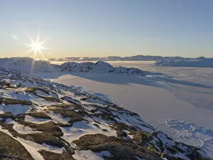 Sunrise during winter at the Ilulissat Icefjord, located in the Disko Bay in West