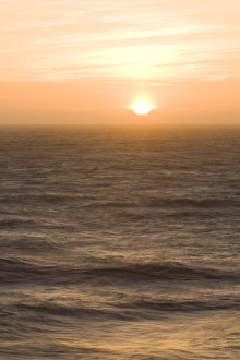 Sunset over the turbulent surf of the Pacific Ocean - San Francisco, California Sunset over the turbulent surf of the Pacific Ocean - San Francisco, California