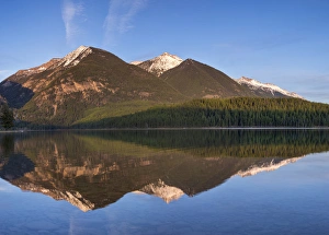 Swan Mountains reflect into calm Holland Lake at sunset in the Lolo National Forest Swan Mountains reflect into calm Holland Lake at sunset in the Lolo National Forest
