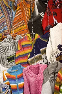 Sweaters and ponchos on display at market, Plaza de San Francisco, Cuenca, Ecuador Sweaters and ponchos on display at market, Plaza de San Francisco, Cuenca, Ecuador