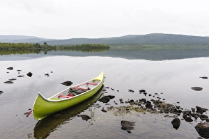 Sweden, Norrbotten, Torne River. Canoe in tranquil waters Sweden, Norrbotten, Torne River. Canoe in tranquil waters
