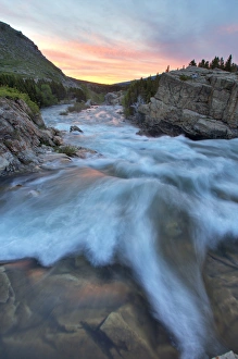 Swiftcurrent Falls catches mornings first light in the Many Glacier Valley of Glacier Swiftcurrent Falls catches mornings first light in the Many Glacier Valley of Glacier