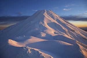 Syme Hut (at left), Fanthams Peak, and Alpenglow at Dawn on Mt Taranaki / Mt Egmont Syme Hut (at left), Fanthams Peak, and Alpenglow at Dawn on Mt Taranaki / Mt Egmont