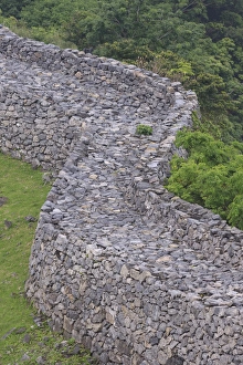 The tall stone walls are all that remain of Nakijin Castle, a 14th Century castle in Okinawa The tall stone walls are all that remain of Nakijin Castle, a 14th Century castle in Okinawa