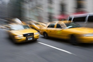 Taxi cabs rush along Park Avenue - Manhattan, New York Taxi cabs rush along Park Avenue - Manhattan, New York