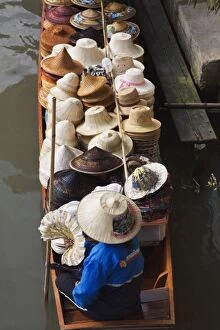 Thai woman selling hats, Damnoen Saduak Floating Market, Damnoen Saduak, Thailand
