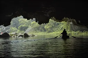 Tourists in cave on Tam Coc (three caves) boat trip on Ngo Dong River, (UNESCO World Tourists in cave on Tam Coc (three caves) boat trip on Ngo Dong River, (UNESCO World