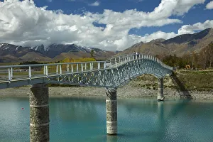 Tourists on pedestrian Bridge over Lake Tekapo outlet, Mackenzie Country, Canterbury Tourists on pedestrian Bridge over Lake Tekapo outlet, Mackenzie Country, Canterbury
