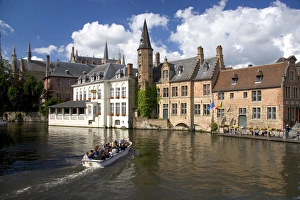 Tourists ride in a canal boat at the city of Bruges in the province of West Flanders Tourists ride in a canal boat at the city of Bruges in the province of West Flanders