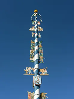 Traditional Bavarian maypole (Maibaum). Village Schliersee in the Bavarian Alps, Bavaria Traditional Bavarian maypole (Maibaum). Village Schliersee in the Bavarian Alps, Bavaria