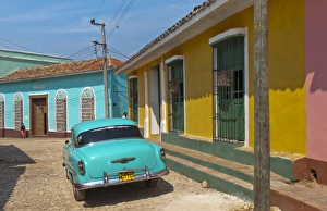Trinidad Cuba with blue classic 1950s Chevrolet auto on cobbled streets in colorful Trinidad Cuba with blue classic 1950s Chevrolet auto on cobbled streets in colorful