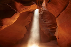United States, Arizona, Navajo Nation, shaft of light and eroded sandstone formations United States, Arizona, Navajo Nation, shaft of light and eroded sandstone formations