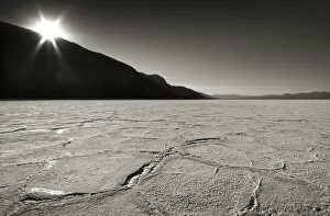 Images Dated 5th November 2007: USA, California, Death Valley. Sunburst over salt pan of Badwater Basin. Credit as