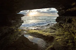 USA, California, La Jolla. Sunset though a sea cave USA, California, La Jolla. Sunset though a sea cave