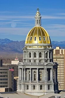 USA, Colorado, Denver. View of state capitol building dome against moonset over the mountains