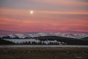 USA, Colorado. Setting full moon and alpenglow above Mosquito Range USA, Colorado. Setting full moon and alpenglow above Mosquito Range