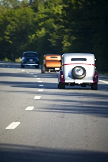 Hot Rod Gallery: USA, Maine. Three antique cars traveling on a modern highway