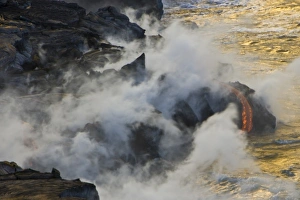 USA. Molten lava flows into the ocean at sunrise in Volcanoes NP on the Big Island of Hawaii USA. Molten lava flows into the ocean at sunrise in Volcanoes NP on the Big Island of Hawaii