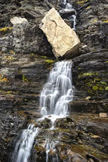 USA, Montana. Boulder and waterfall in Glacier National Park USA, Montana. Boulder and waterfall in Glacier National Park