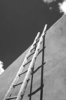 USA, New Mexico, Taos. Ladder on side of pueblo building