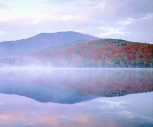 USA; New York; Algonquin Peak and autumn colors relecting in a misty Heart Lake in USA; New York; Algonquin Peak and autumn colors relecting in a misty Heart Lake in