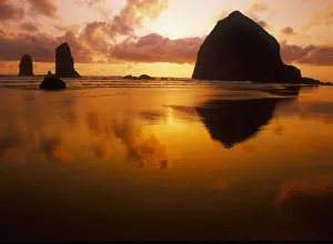 USA, Oregon, Cannon Beach Haystack Rock silhouetted at sunset USA, Oregon, Cannon Beach Haystack Rock silhouetted at sunset
