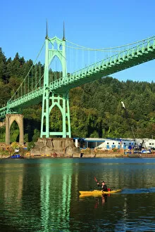 Images Dated 25th August 2012: USA, Oregon, Portland, Cathedral Park, kayaker paddling under the St. Johns Bridge
