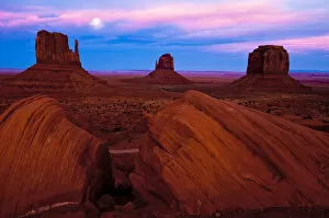 USA, Utah, Monument Valley. Moonrise over sandstone formations in valley. Credit as