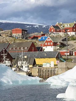 Uummannaq harbor and town, northwest of Greenland, located on an island in the Uummannaq Uummannaq harbor and town, northwest of Greenland, located on an island in the Uummannaq