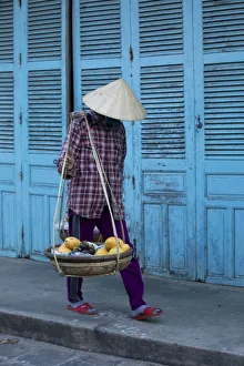 Vietnam. Street vendor with fruit and vegetable basket. Hoi Anh Vietnam. Street vendor with fruit and vegetable basket. Hoi Anh