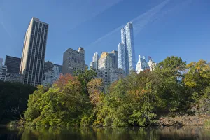 View of highrise buildings along Central Park South from inside Central Park on a sunny View of highrise buildings along Central Park South from inside Central Park on a sunny