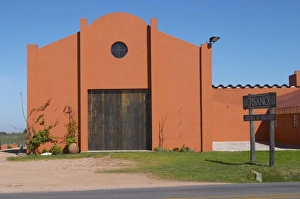 A view over the main winery building and a sign to the winery. Painted in ochre red A view over the main winery building and a sign to the winery. Painted in ochre red