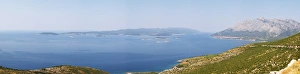 View over the Orebic village town and the Sveti Ilija mountain, dark blue sea towards View over the Orebic village town and the Sveti Ilija mountain, dark blue sea towards