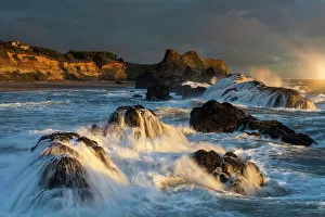 Crashing Gallery: Waves crashing on rocks and washing down the sides at sunset