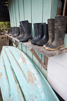 Wet season supplies including rubber boots, canoes and oars line a shed at Sirena Wet season supplies including rubber boots, canoes and oars line a shed at Sirena